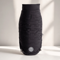 Flip & Cozy™ Reversible Quilted Dog Jacket in black on a white tabletop