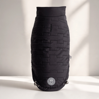 Flip & Cozy™ Reversible Quilted Dog Jacket in black on a white tabletop